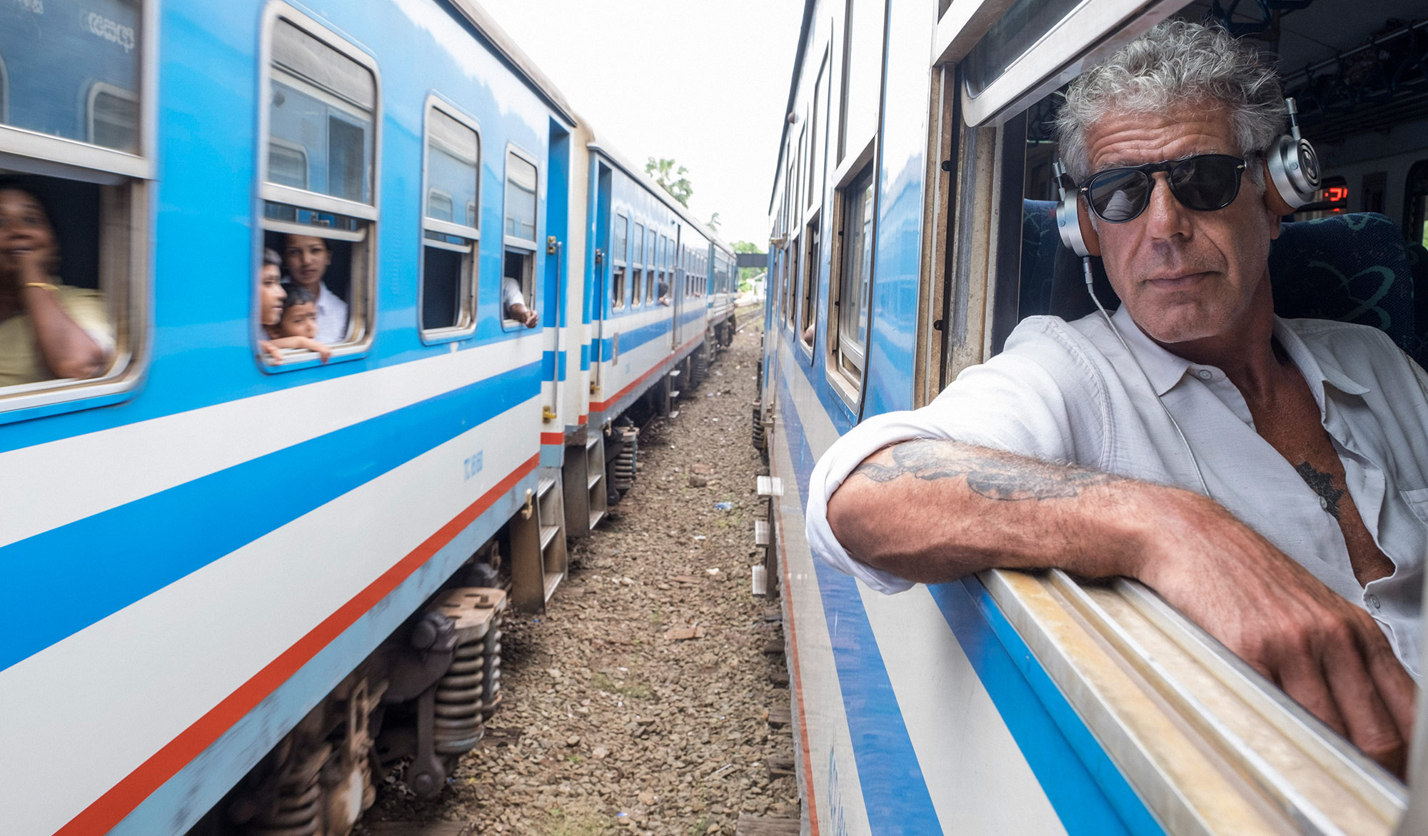 Anthony Bourdain leaning out of a train window in Sri Lanka