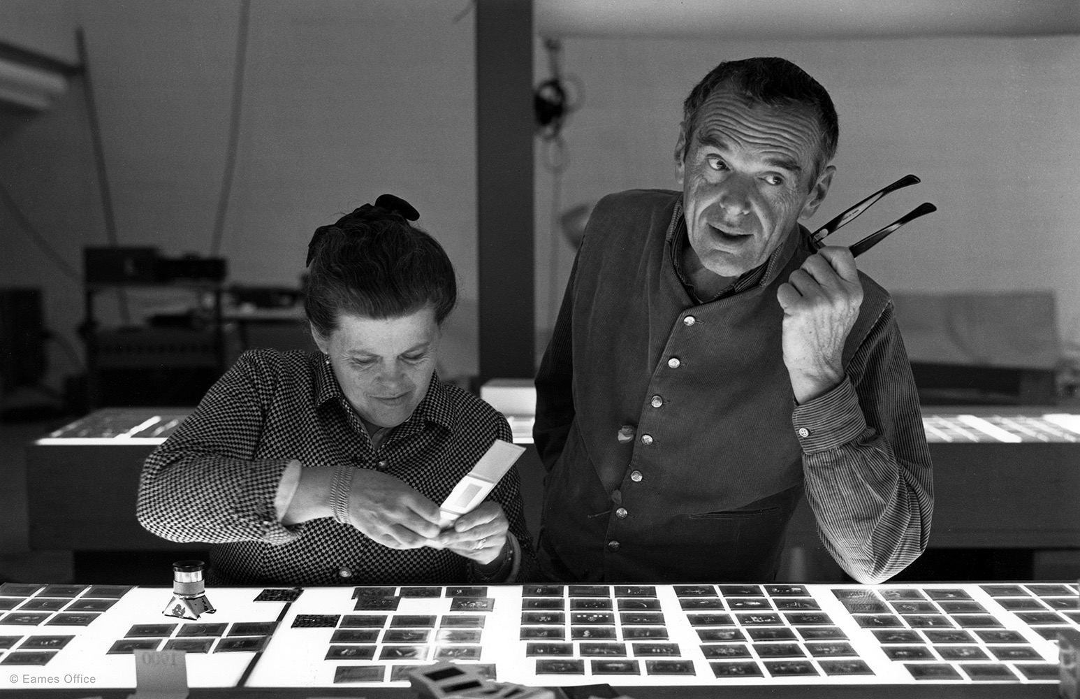 Charles and Ray Eames reviewing photographic slides