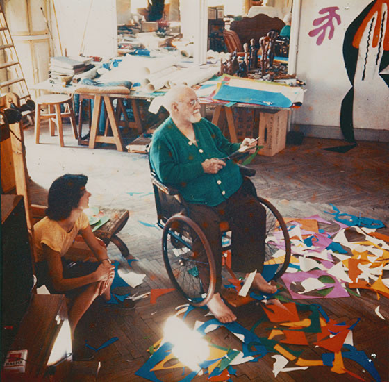 Henri Matisse creating paper cutouts from his wheelchair, 1953