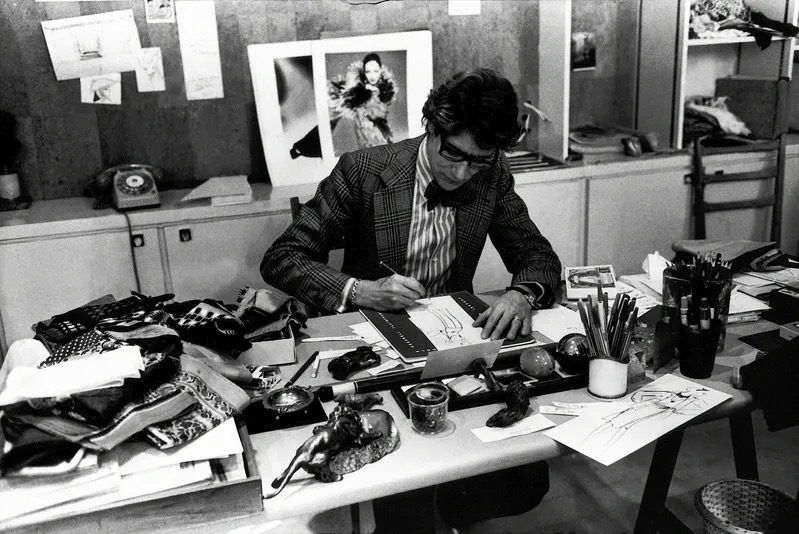 Yves Saint Laurent working at his desk